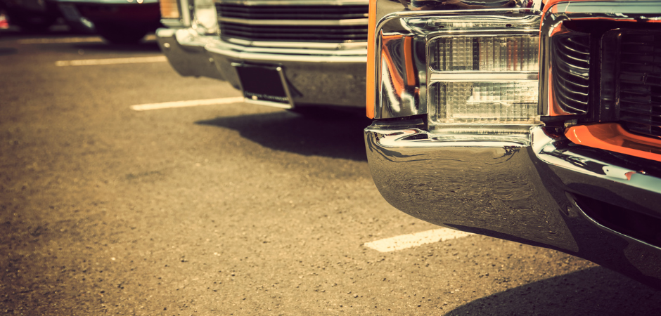 Close-up view of classic cars from the 70s parked in a row.  