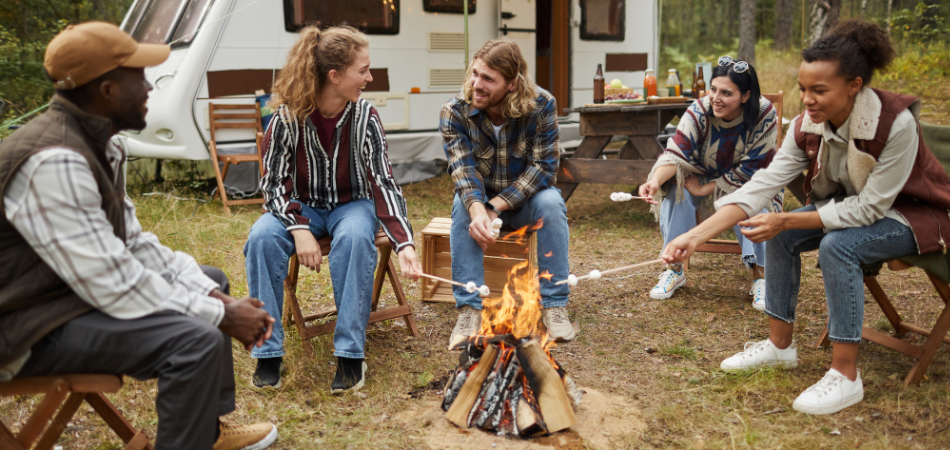 RV campers set up at a campground following RV camping etiquette, with trailers parked within designated spaces.  