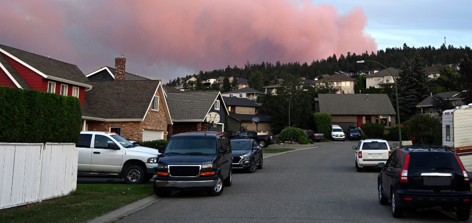 A Canadian home surrounded by trees during heightened wildfire risk conditions.  