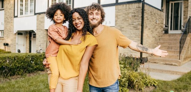 A family standing in front of a house