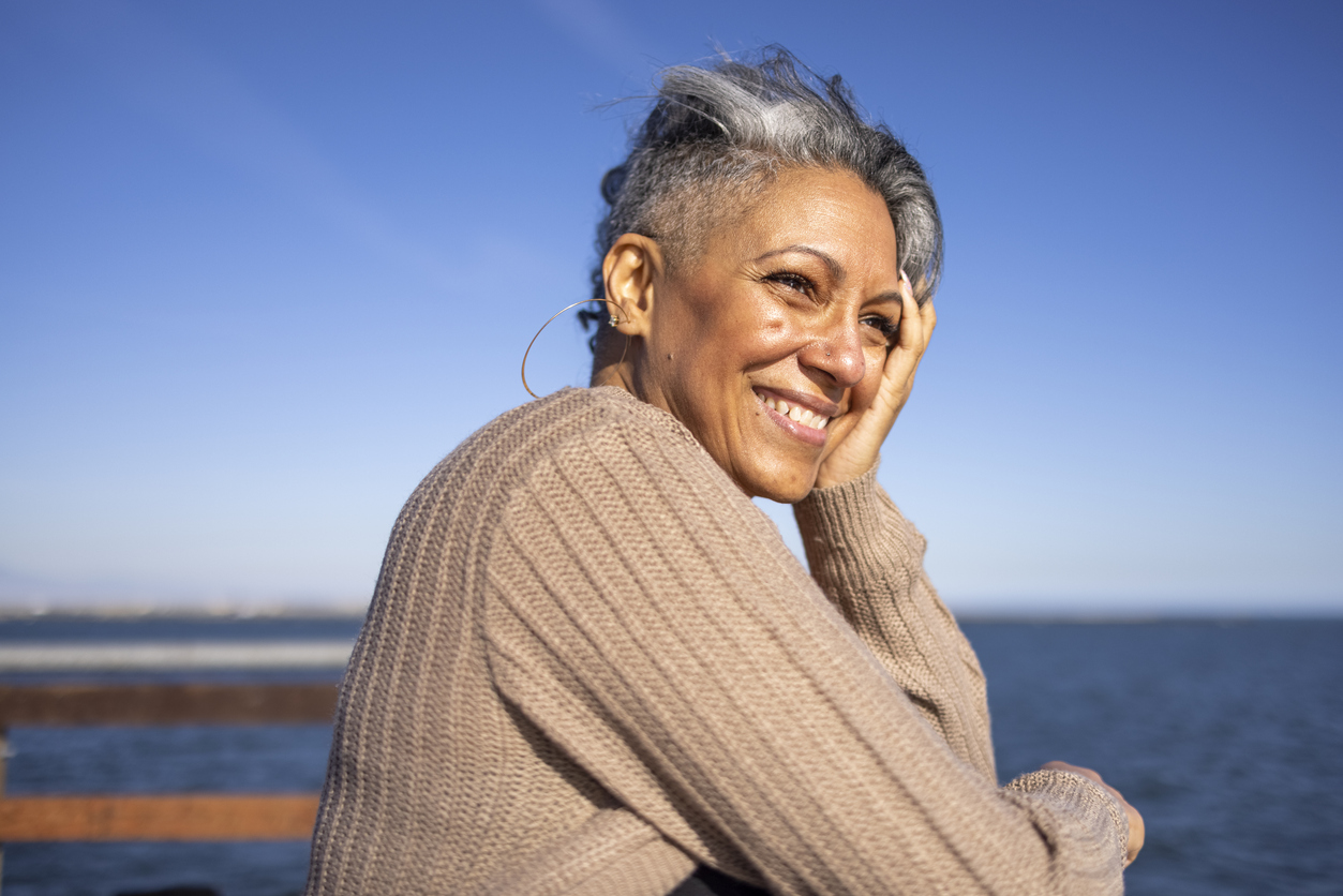 A woman enjoying the scenery by the water