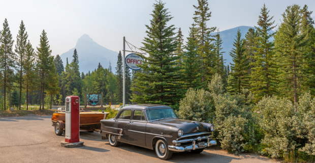 Vintage car and old-style gas station at Johnston Canyon entrance, Banff national park, Canada.